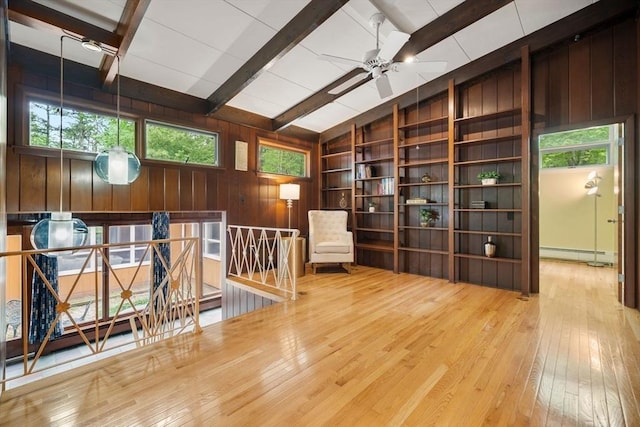 181 Thayer Farms Rd, Attleboro, MA 02703 - living area with a baseboard heating unit, hardwood / wood-style flooring, ceiling fan, wooden walls, and an upstairs landing