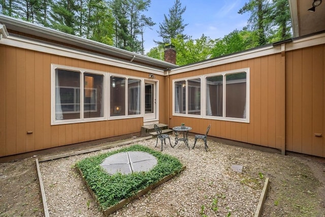 181 Thayer Farms Rd, Attleboro, MA 02703 - back of property featuring a chimney and a patio area
