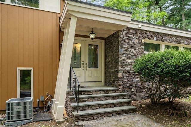 181 Thayer Farms Rd, Attleboro, MA 02703 - property entrance with central AC, stone siding, and french doors