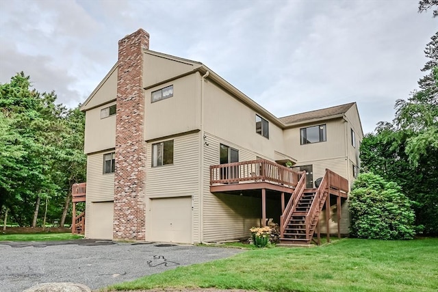 9 Country Club Ln Unit A, Milford, MA 01757 - rear view of house featuring stairway, a wooden deck, an attached garage, and a yard