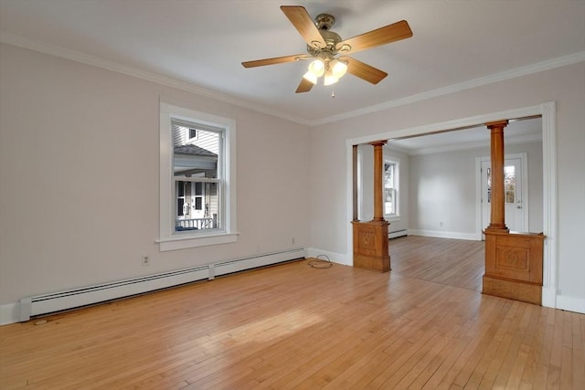 unfurnished room featuring light hardwood / wood-style floors, ornamental molding, ceiling fan, a baseboard heating unit, and decorative columns