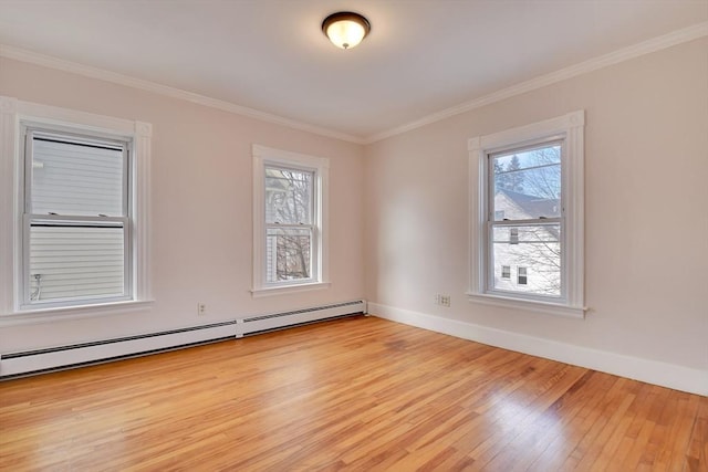 spare room with baseboard heating, light hardwood / wood-style floors, and crown molding