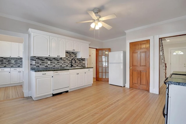 kitchen with white appliances, tasteful backsplash, ceiling fan, white cabinets, and sink