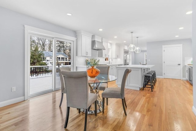 dining area featuring light wood-type flooring, baseboards, and recessed lighting