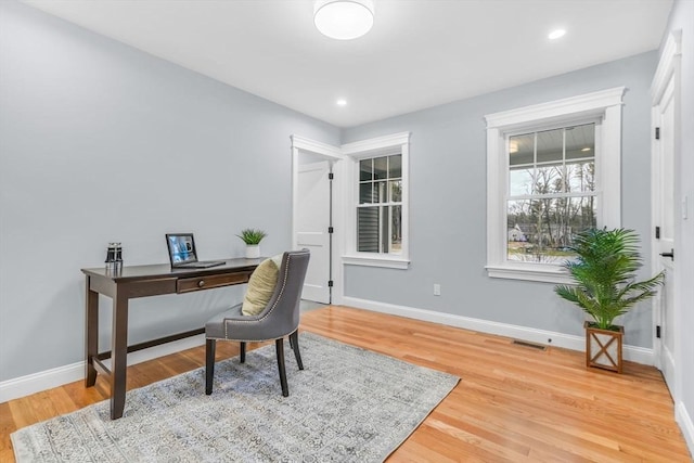 home office with baseboards, recessed lighting, visible vents, and light wood-style floors