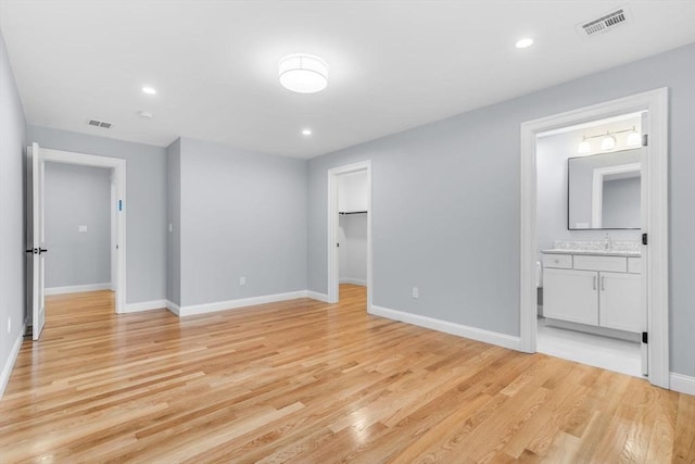 unfurnished bedroom with light wood-style floors, recessed lighting, visible vents, and baseboards