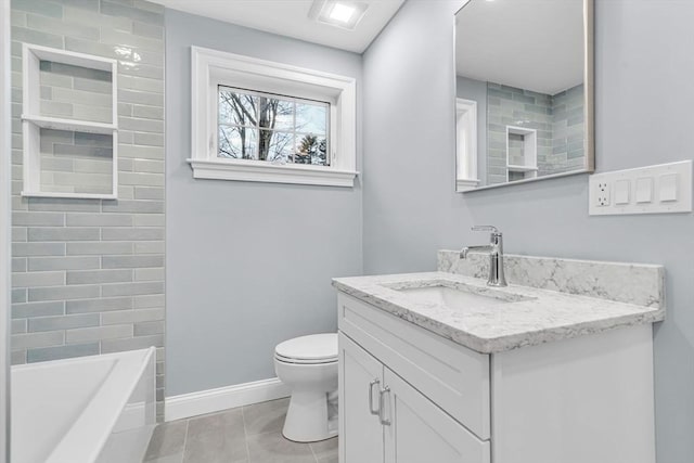 bathroom featuring baseboards, toilet, tile patterned flooring, a bathtub, and vanity