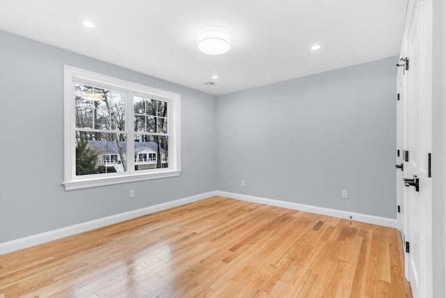 unfurnished room featuring light wood-type flooring, baseboards, and recessed lighting