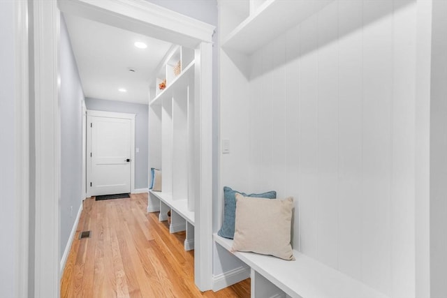 mudroom with light wood-style floors, visible vents, and baseboards