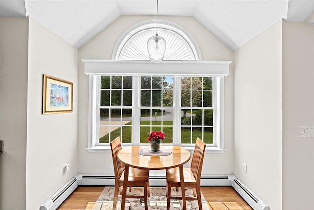 11 Quashnet Woods Dr, Mashpee, MA 02649 - dining area featuring light wood-type flooring, lofted ceiling, and a baseboard radiator