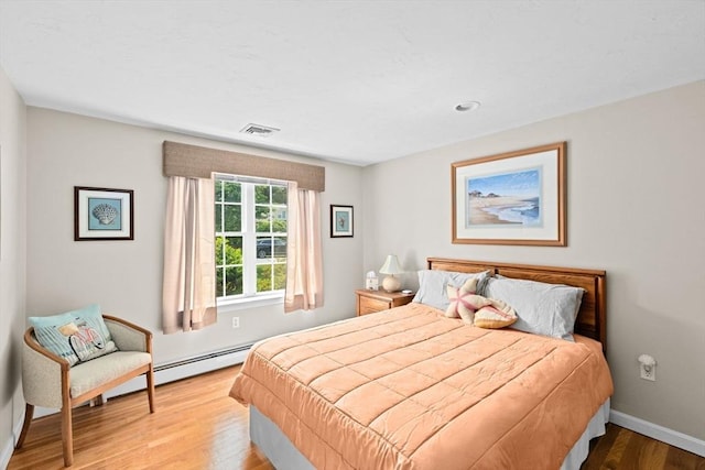 11 Quashnet Woods Dr, Mashpee, MA 02649 - bedroom with wood finished floors and baseboard heating