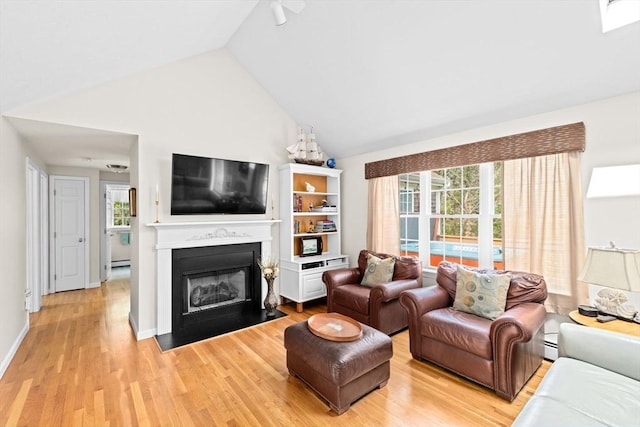11 Quashnet Woods Dr, Mashpee, MA 02649 - living room featuring a fireplace with flush hearth, light wood-style floors, and lofted ceiling