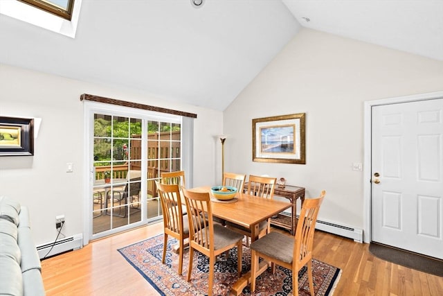 11 Quashnet Woods Dr, Mashpee, MA 02649 - dining room with a baseboard radiator, light wood finished floors, a skylight, and high vaulted ceiling