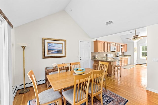 11 Quashnet Woods Dr, Mashpee, MA 02649 - dining room featuring light wood-type flooring, high vaulted ceiling, ceiling fan, and baseboard heating