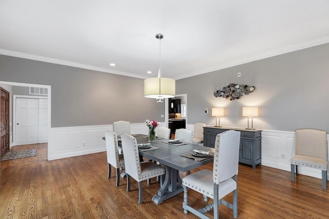 dining space featuring dark hardwood / wood-style flooring and crown molding