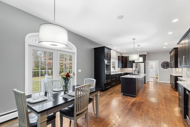 dining area featuring baseboard heating and dark wood-type flooring