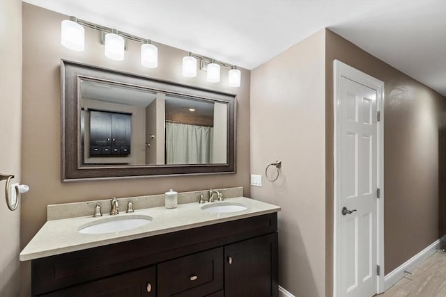 bathroom with hardwood / wood-style flooring and vanity