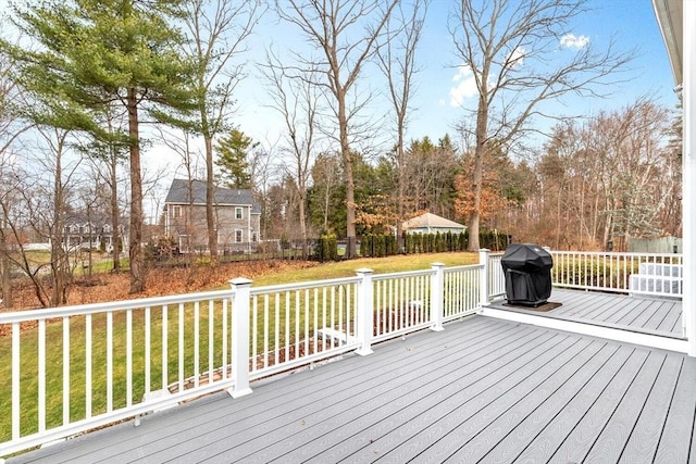 wooden terrace featuring a yard and grilling area