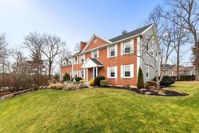 colonial-style house featuring a front yard