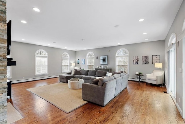 living room featuring wood-type flooring and a baseboard radiator