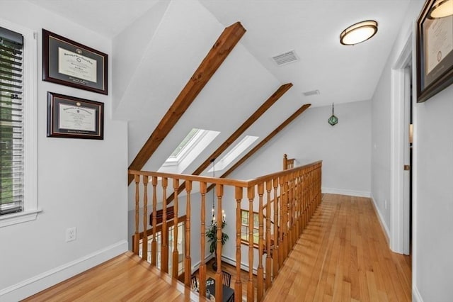 35 Crest Rd, Lynnfield, MA 01940 - corridor featuring a skylight, an upstairs landing, wood finished floors, and lofted ceiling