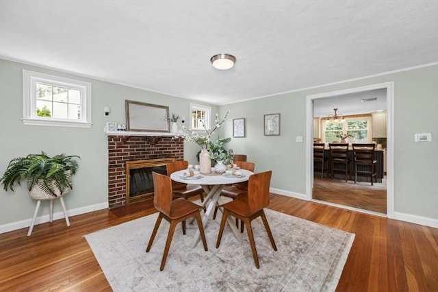 35 Crest Rd, Lynnfield, MA 01940 - dining space with a fireplace, wood finished floors, and crown molding