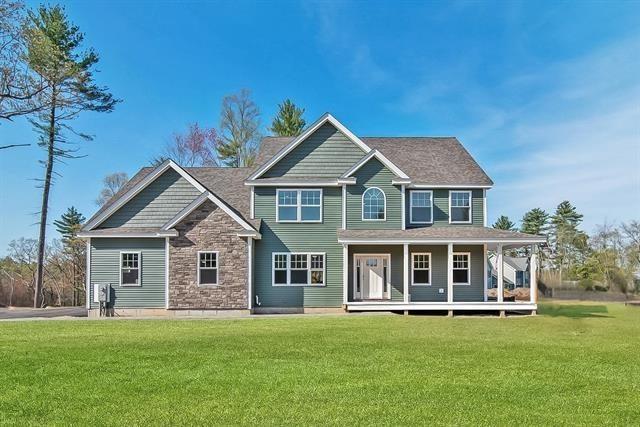 6 Carmel Rd, Pelham, NH 03076 - view of front of house featuring covered porch, stone siding, and a front lawn