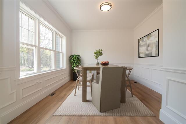 6 Carmel Rd, Pelham, NH 03076 - dining room with ornamental molding, wood finished floors, wainscoting, and a decorative wall