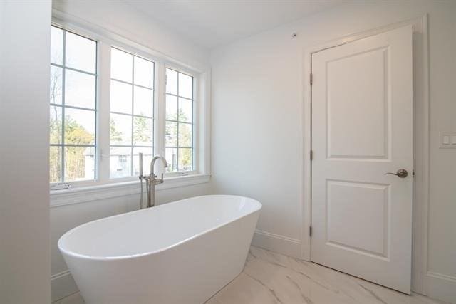 6 Carmel Rd, Pelham, NH 03076 - bathroom with a freestanding bath, marble finish floors, and baseboards