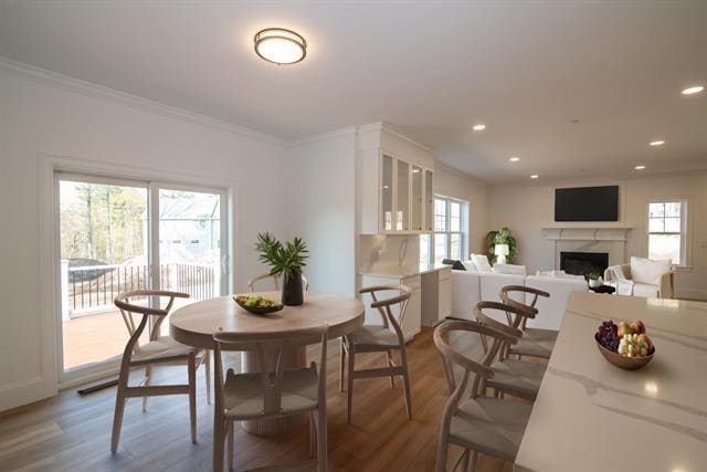 6 Carmel Rd, Pelham, NH 03076 - dining space featuring plenty of natural light, ornamental molding, a fireplace, recessed lighting, and wood finished floors