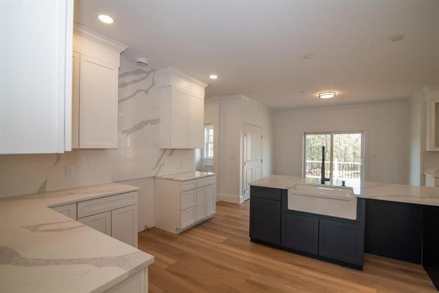6 Carmel Rd, Pelham, NH 03076 - kitchen with a sink, light stone counters, white cabinetry, light wood finished floors, and recessed lighting