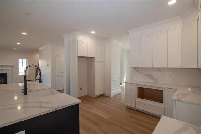 6 Carmel Rd, Pelham, NH 03076 - kitchen featuring crown molding, white cabinetry, recessed lighting, light wood finished floors, and a fireplace