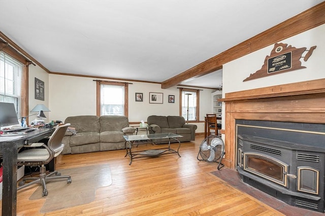145 Lexington Rd, Billerica, MA 01821 - living room featuring light wood finished floors, crown molding, a desk, a wood stove, and beamed ceiling