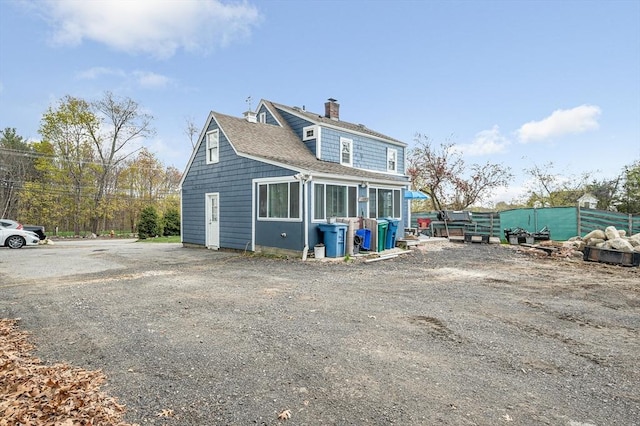 145 Lexington Rd, Billerica, MA 01821 - view of front facade with a chimney and roof with shingles