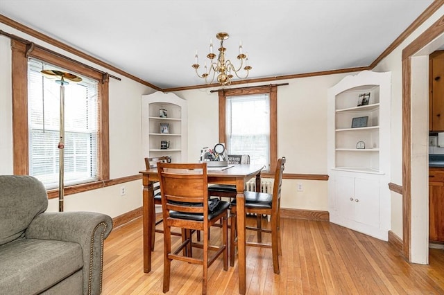 145 Lexington Rd, Billerica, MA 01821 - dining room with light wood-style flooring, crown molding, a chandelier, baseboards, and healthy amount of natural light