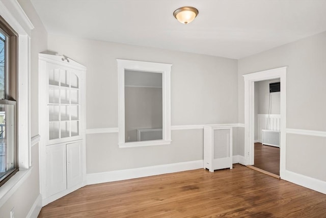 spare room with wood-type flooring