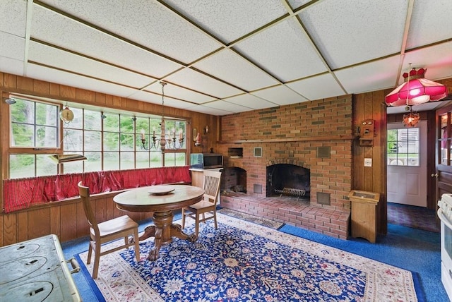 19 Buffington Hill Rd, Worthington, MA 01098 - dining room featuring wooden walls and a brick fireplace