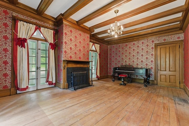 19 Buffington Hill Rd, Worthington, MA 01098 - unfurnished living room with wallpapered walls, a chandelier, beam ceiling, healthy amount of natural light, and a fireplace with flush hearth