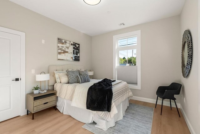 bedroom featuring light wood-style flooring and baseboards
