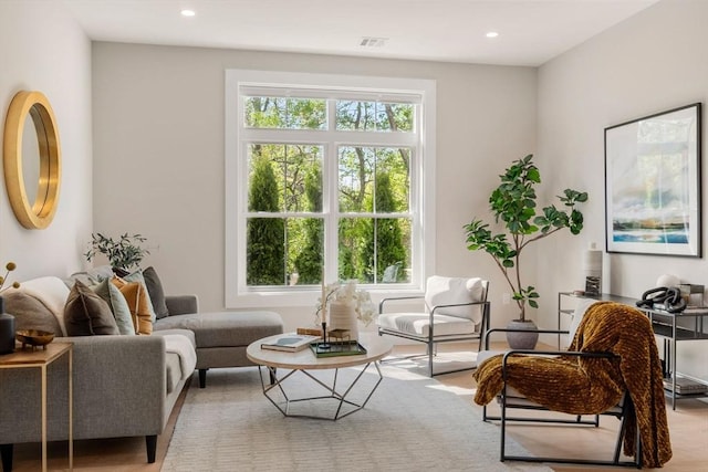 living area with plenty of natural light, recessed lighting, and wood finished floors