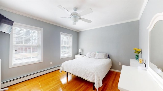 bedroom featuring a baseboard radiator, wood finished floors, crown molding, and a ceiling fan