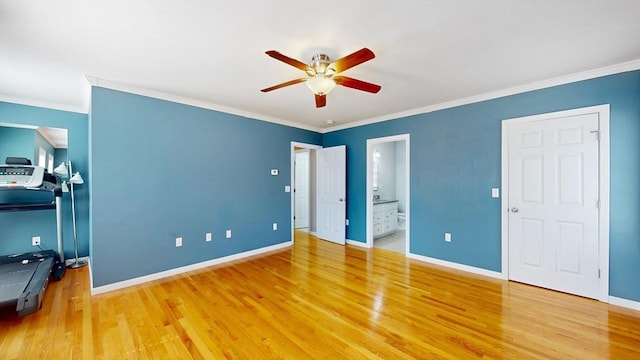 unfurnished bedroom with wood finished floors, baseboards, and ornamental molding