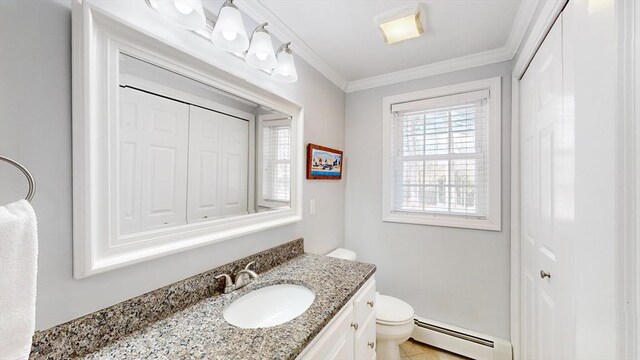 bathroom featuring baseboard heating, crown molding, a closet, vanity, and toilet