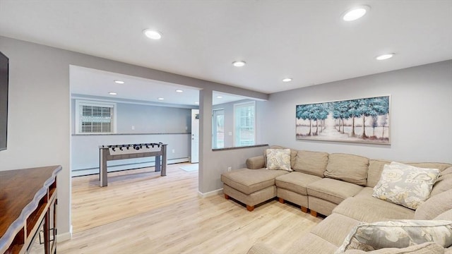 living area featuring light wood finished floors, baseboards, and recessed lighting