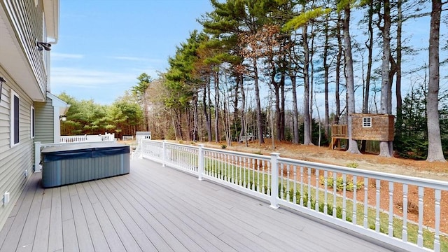 wooden deck featuring a hot tub