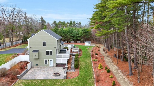 view of home's exterior featuring a wooden deck, a yard, a patio, and fence