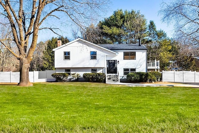 11 Adams St, Foxboro, MA 02035 - split foyer home with a chimney, fence, and a front yard