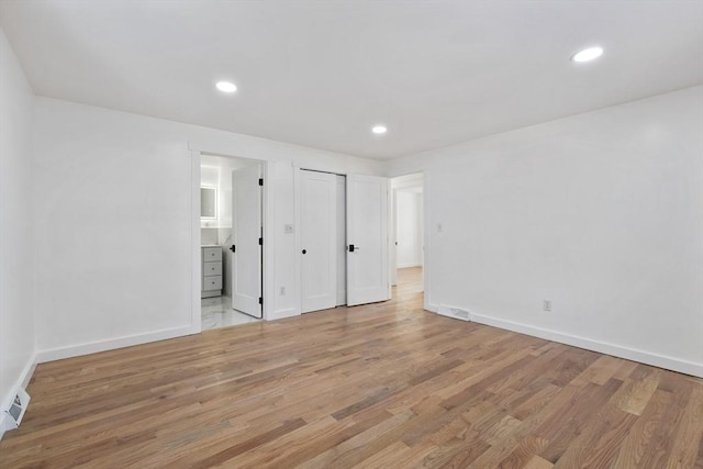 11 Adams St, Foxboro, MA 02035 - unfurnished bedroom featuring baseboards, recessed lighting, connected bathroom, and wood finished floors