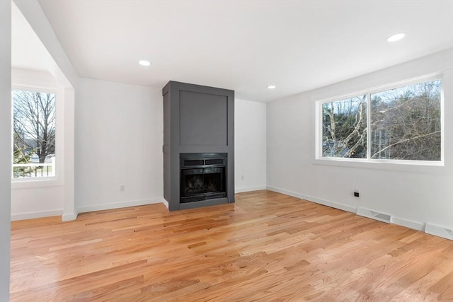 11 Adams St, Foxboro, MA 02035 - unfurnished living room featuring visible vents, light wood-style floors, baseboards, recessed lighting, and a large fireplace