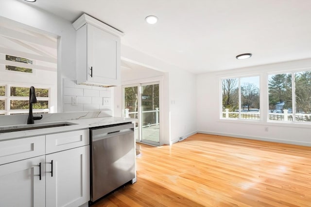 11 Adams St, Foxboro, MA 02035 - kitchen featuring white cabinets, light stone countertops, a sink, light wood-style flooring, and stainless steel dishwasher